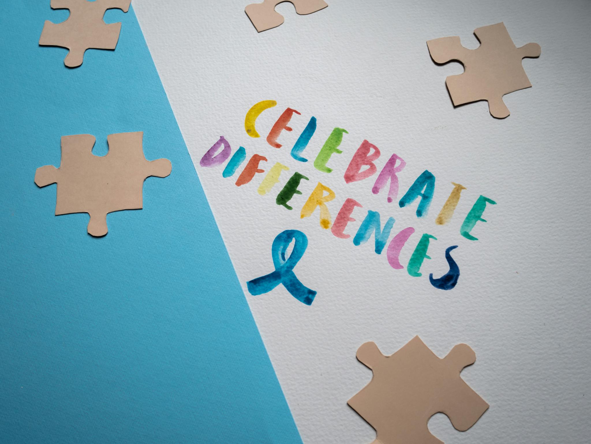 Colorful typography and puzzle pieces celebrate diversity and uniqueness.