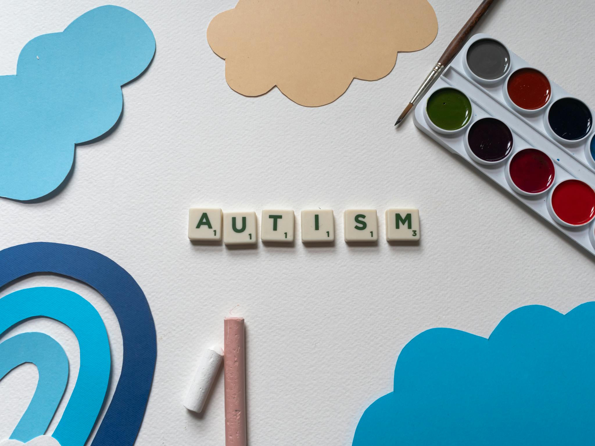 Creative art materials with autism awareness theme displayed in a flatlay style.